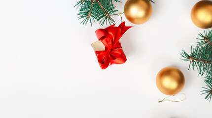Golden Christmas balls with gift on white background. Festive Christmas decoration of gold glitter. Happy new year.