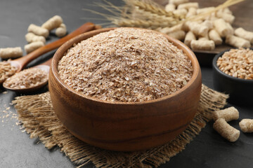 Wheat bran in bowl on black table