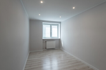 Contemporary apartment. Light interior of renovated room. Parquet floor. Window on wall. Nobody.