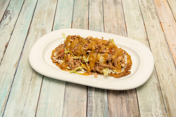 Venezuelan plantain patacon recipe with shredded chicken meat, lettuce and sweet curry sauce