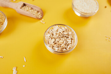 Flat lay of set of heap various grains and cereals on yellow background