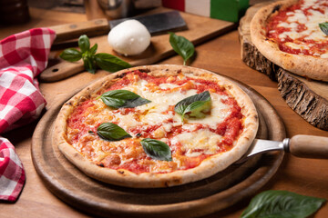 Pizza margarita topped with fresh basil leaves