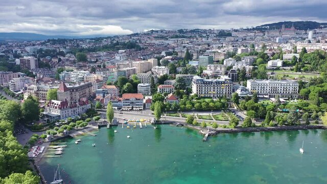 View from Lake Leman of residential areas of Swiss city of Lausanne in cloudy summer day, canton of Vaud in Romandy
