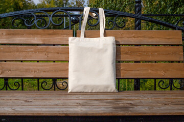 Rustic tote bag on the park bench mockup