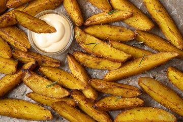 Golden potato slices baked on the grill with cheese sauce
