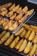 Golden potato slices on gas grill