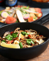Fried pig ears with sesame seeds and green onions close-up. Fried pig ears in korean style.