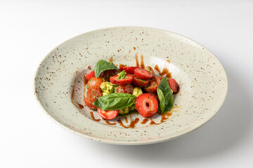 Caprese salad with strawberries. Salad with mozzarella, tomatoes, basil and strawberries.