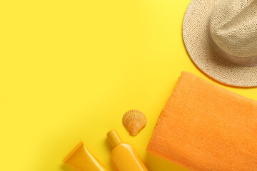Flat lay composition with different beach objects on yellow background, space for text