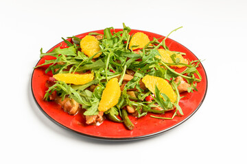 Delicious mixed vegetable and fruit salad served in a red plate over white background.