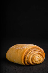 Cinnamon roll on dark background