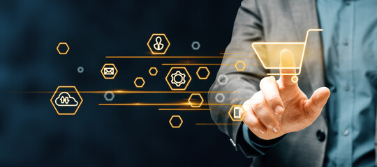 Man hand pointing at abstract glowing online shopping icons on blurry blue background. Buy,...