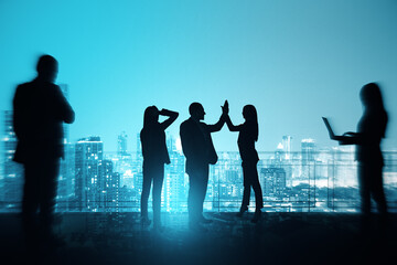 Group of businesspeople with hi-five gesture standing on night city sky with mock up place background. Success, teamwork and communication concept.