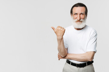 European senior man pointing finger aside while looking at camera