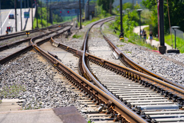 Fototapeta premium Tracks and railway switch at train station of Nyon on a sunny summer afternoon. Photo taken August 11th, 2021, Nyon, Switzerland.