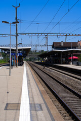 Naklejka premium Train station at City of Nyon on a sunny summer afternoon. Photo taken August 11th, 2021, Nyon, Switzerland.