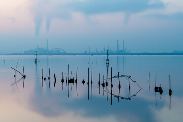 Beautiful sunset in the lagoon of Venice with calm water in the industrial area of Porto Marghera