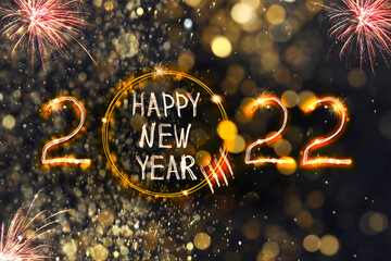 Bright text Happy New 2022 Year made of firework on dark background. Greeting card design