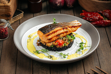 Gourmet salmon fillet with creamy basil sauce and black rice