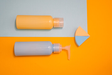 Artistic fashion photo cosmetics product face care serum and cream of blue and yellow colours on a blue and yellow background. 