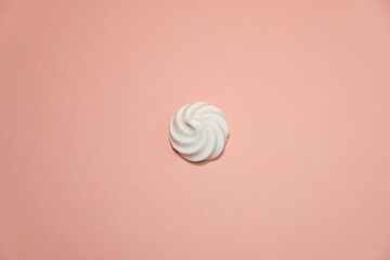 Closeup of french mini meringues cookies on pink as food background.