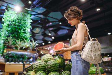 Young smiling happy caucasian woman 20s wear casual clothes shopping at supermaket greengrocery...