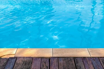 Wide swimming pool and brown stone floor inside the villa