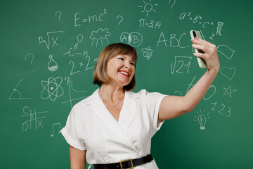 Teacher mature elderly senior lady woman 55 wear white shirt do selfie shot on mobile cell phone...