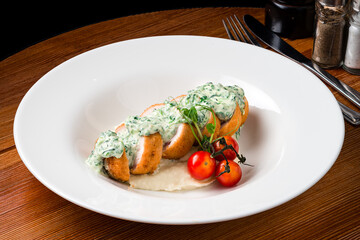 Sliced chicken cordon bleu with creamy sauce