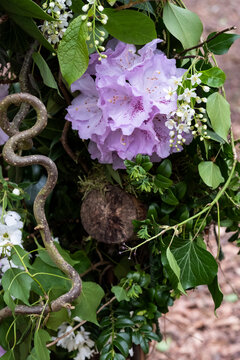 Garland with ivy and pink flowers, decorations for a woodland ceremony
