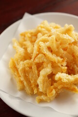 Close up of Delicious golden yellow crispy fish maw is Asian food and snack.
