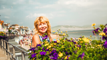 Fototapeta na wymiar Middle aged beautiful woman is enjoying her holidays on the beach in the UK
