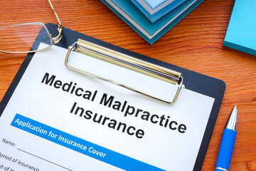 Medical malpractice insurance application and clipboard.
