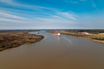 aerial view of the parana river, a cargo ship on the horizon.