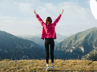 cheerful woman in the mountains nature outdoor activities jump