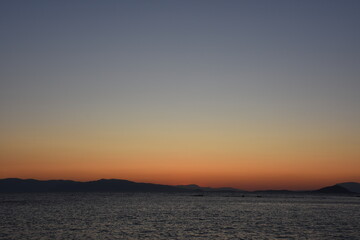 Naklejka na ściany i meble sunset on the sea over the port in Aegina in Greece