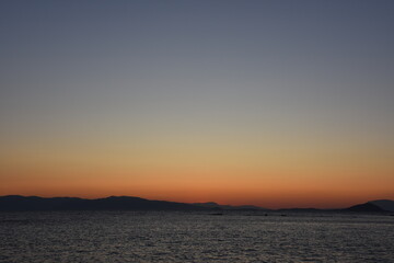 sunset on the sea over the port in Aegina in Greece