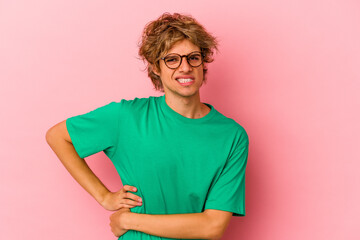 Young caucasian man with make up isolated on pink background having a liver pain, stomach ache.