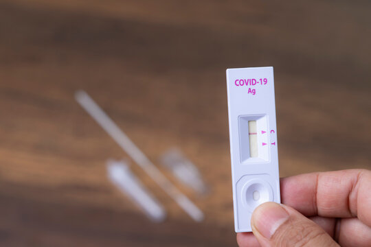 Hand with holding Rapid kits of Covid-19 Ag test or ATK