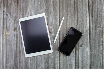mock up tablet and mobile phone on old wooden desk