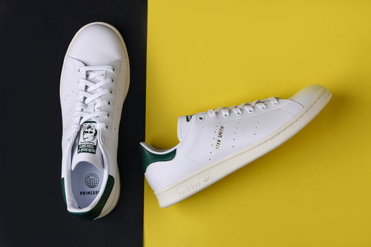 Jeddah Saudi Arabia  August 21 2021  ADIDAS stan smith endorsed by shoes, on yellow background. Product shot. Adidas is a German corporation that designs and manufactures sports shoes