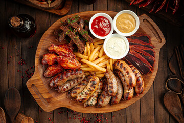 Wooden tray of beer appetizers set assortment with sauces