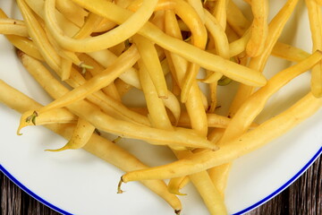 Fresh Yellow wax string beans on a dark wooden board background. Organic vegetables from farmer market, vegan food concept.Fresh Butter bean 