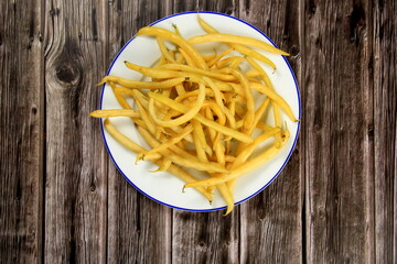 Fresh Yellow wax string beans on a dark wooden board background. Organic vegetables from farmer market, vegan food concept.Fresh Butter bean 