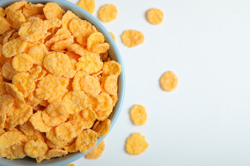Delicious cornflakes in a plate on a light background.