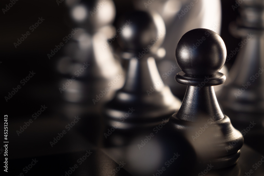 Wall mural Closeup shot of chess pieces on dark background