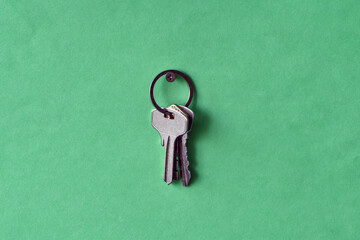 Hanging keys on the green wall, Various three keys hanging on green background. - 452512686