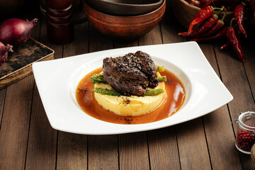 Grilled beef pepper steak with mashed potatoes and asparagus