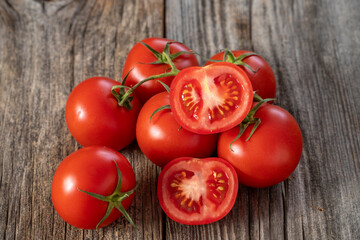 fresh ripe bunch tomatoes on wood background