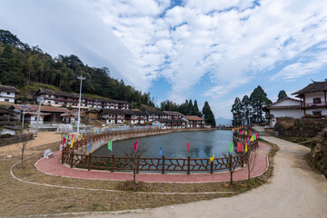 Fototapeta premium Beautiful mountain village, with lake, blue sky, house and grassland